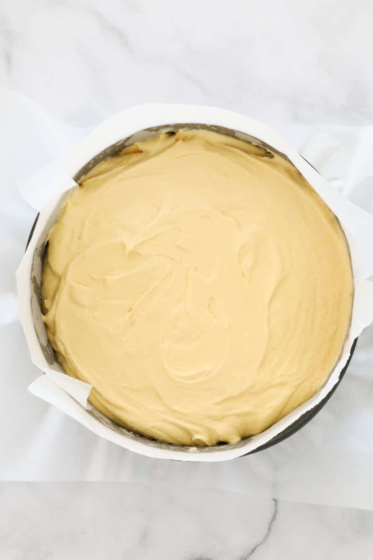 Batter poured into a round baking tin lined with baking paper.
