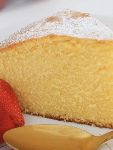 A slice of tall, light and fluffy custard cake.
