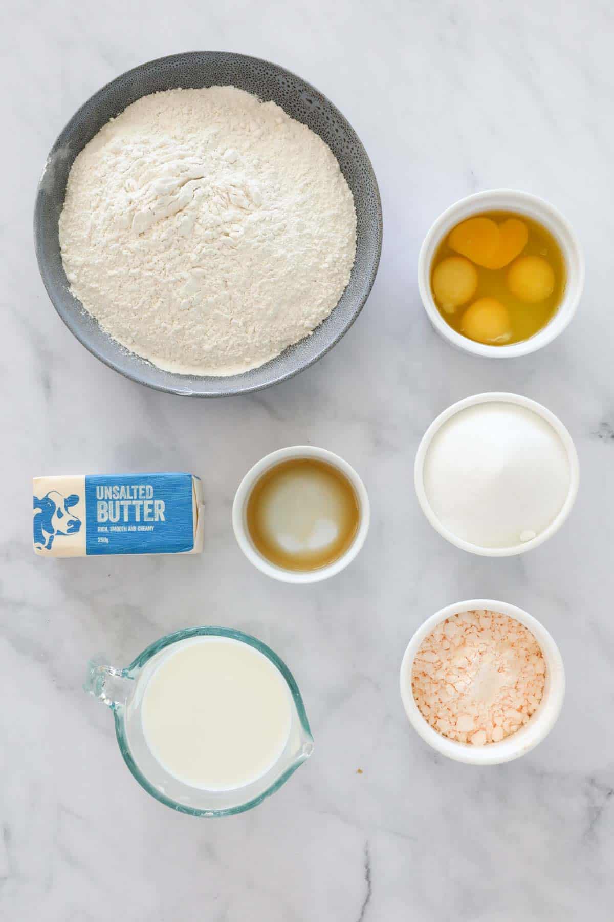 The ingredients needed for a cake weighed out in individual bowls.