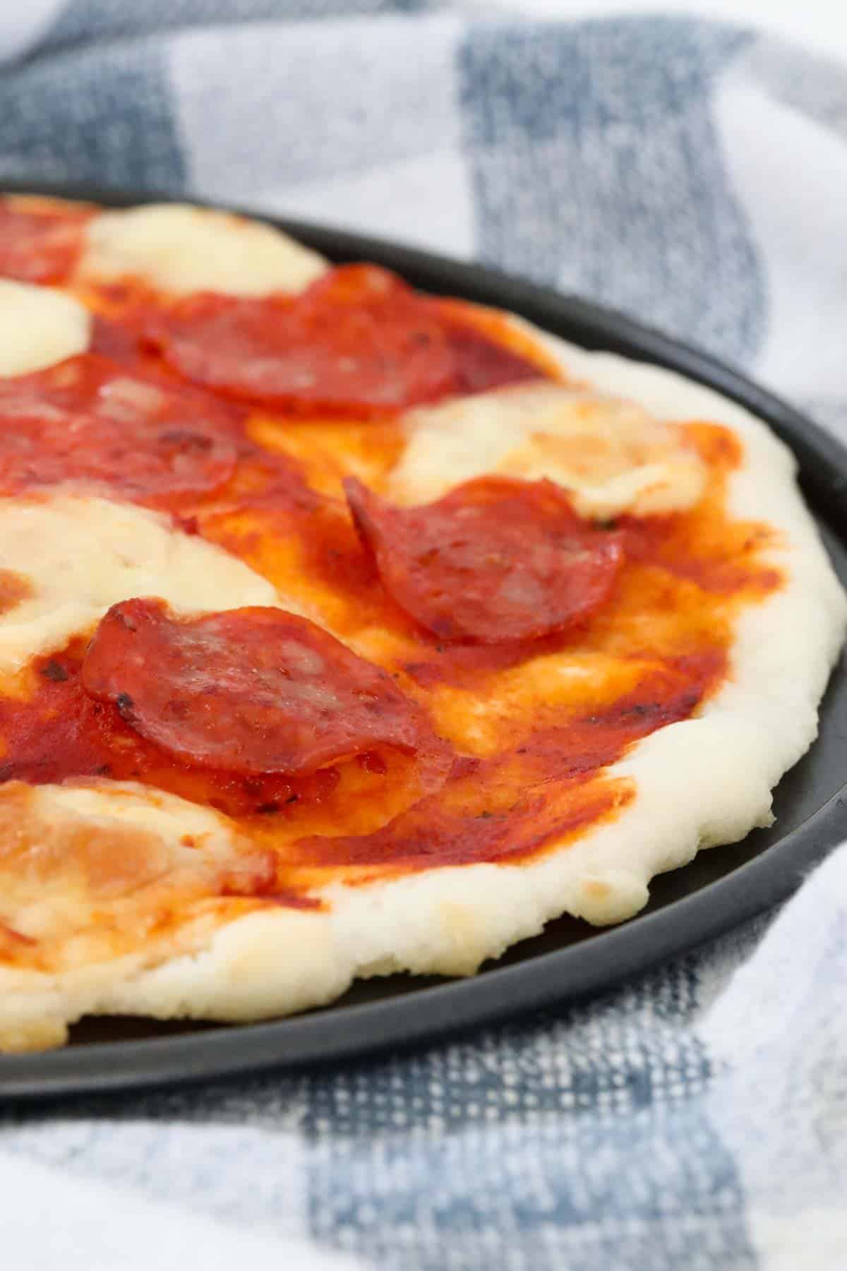A gluten free pizza with pepperoni and cheese.