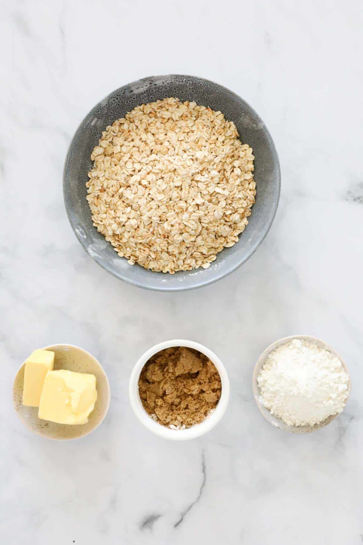 Ingredients for a crunchy topping in individual bowls.