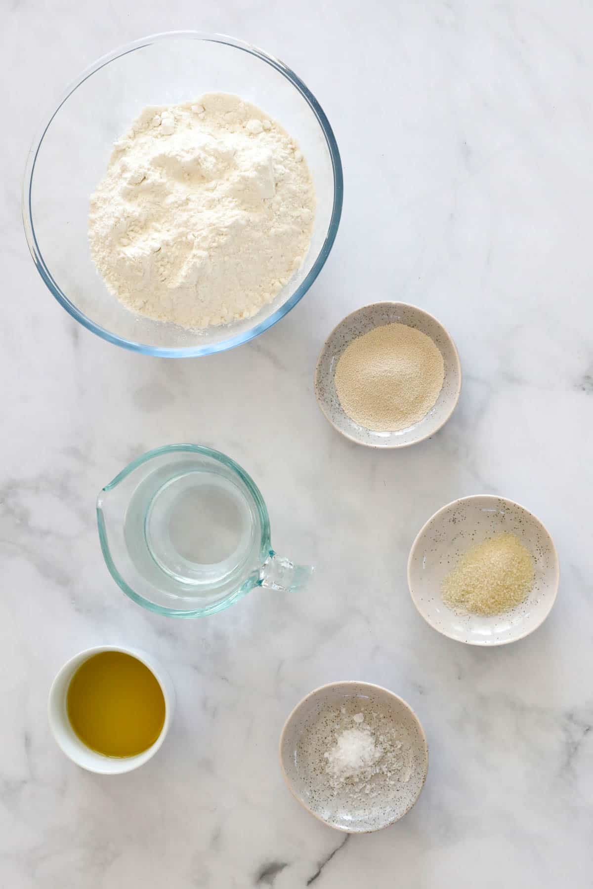 The six ingredients for homemade pizza dough.