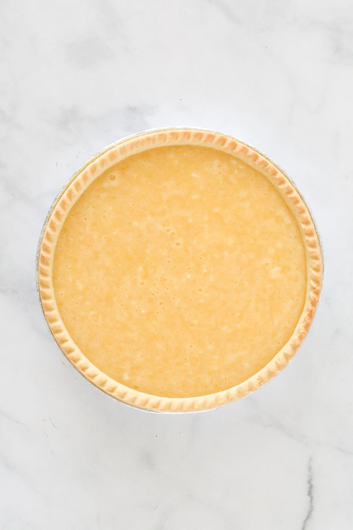 Egg and coconut filling poured into a pre-bought shortcrust pastry shell.