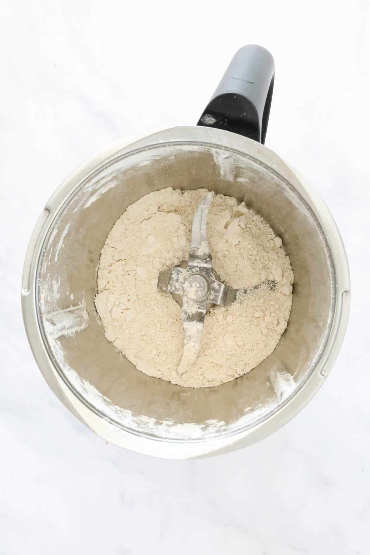Oats blended to a fine powder in the bottom of a blender.