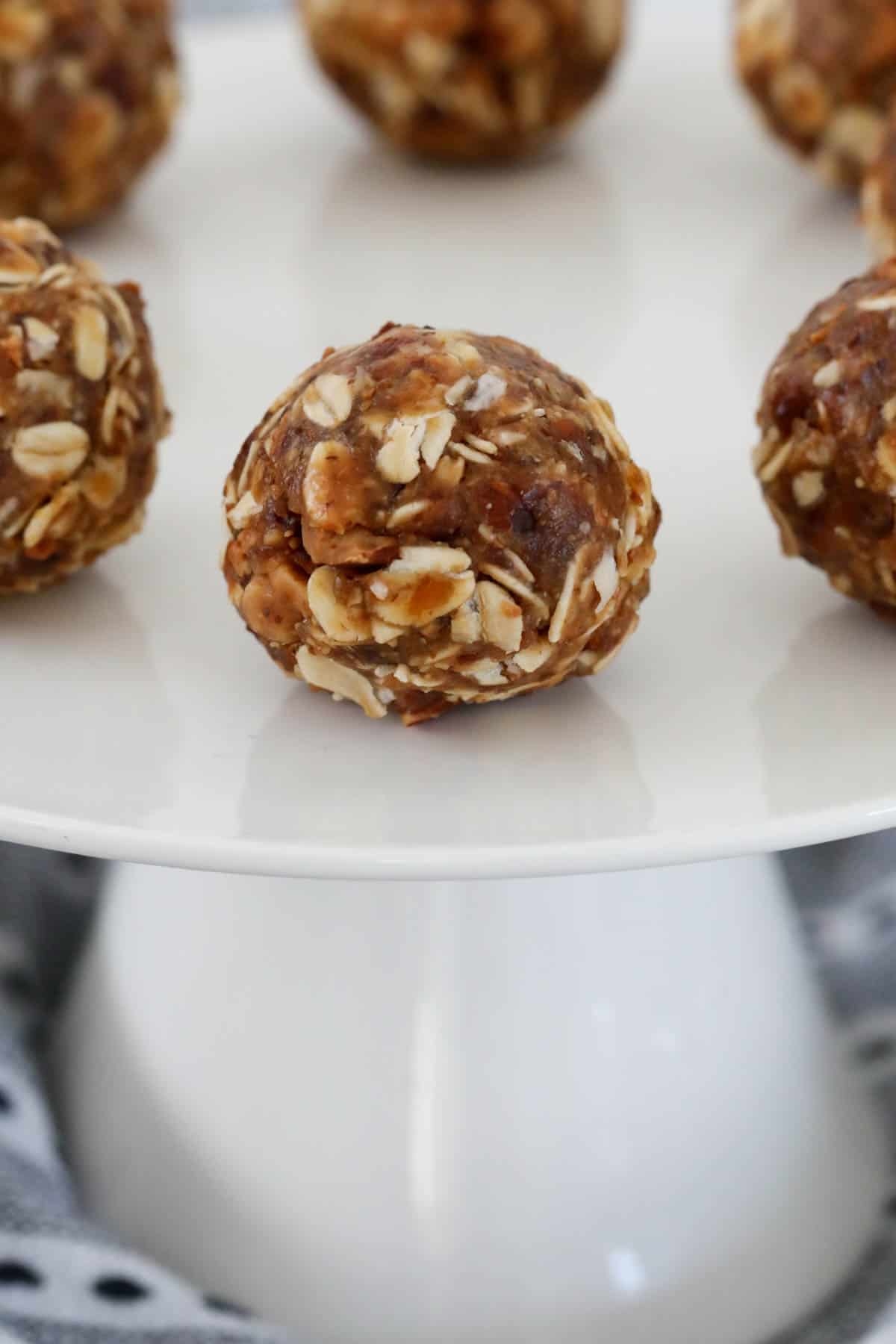 A healthy almond, oat & date ball on a cake stand.