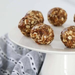 A close up of round energy balls full of oats, chopped dates and almonds.
