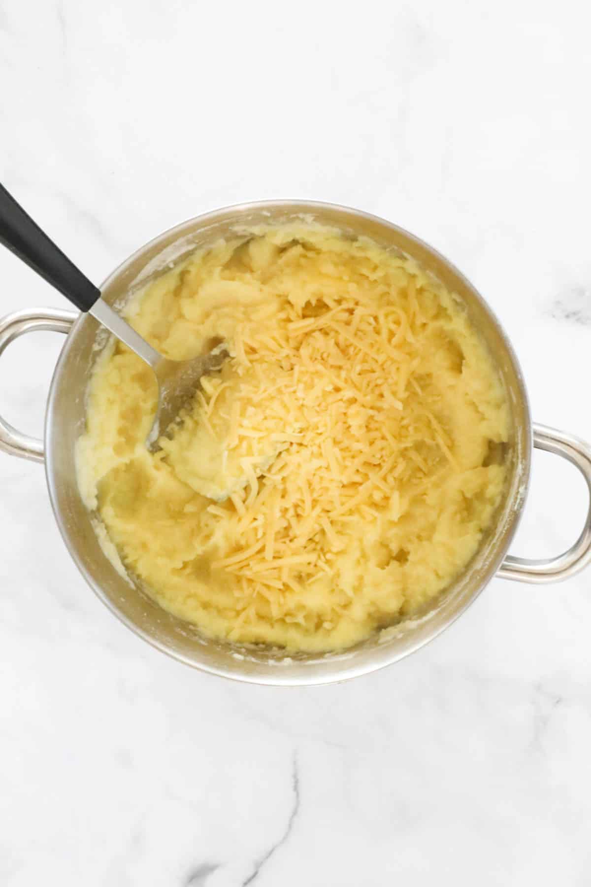 Grated cheese added to mashed potato.