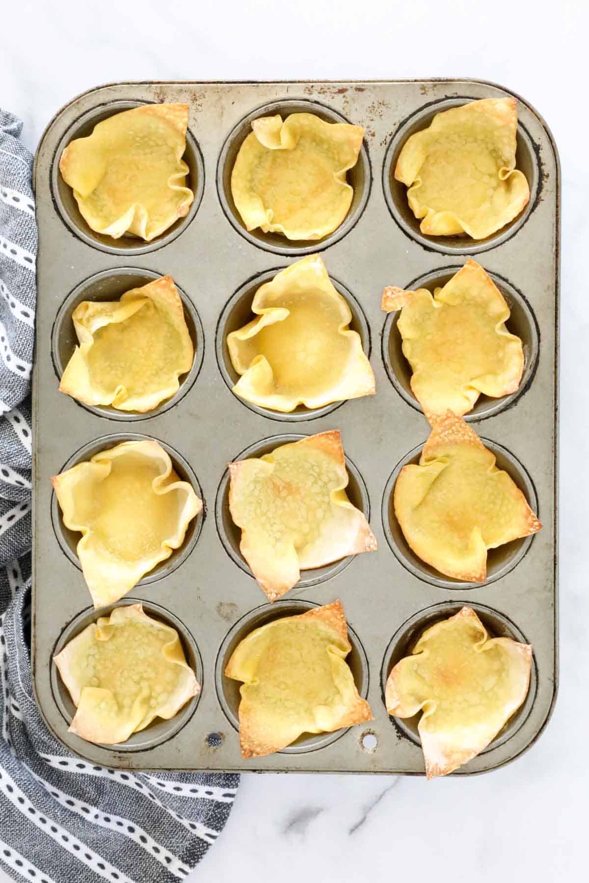 Wonton wrappers baked in a muffin tin.