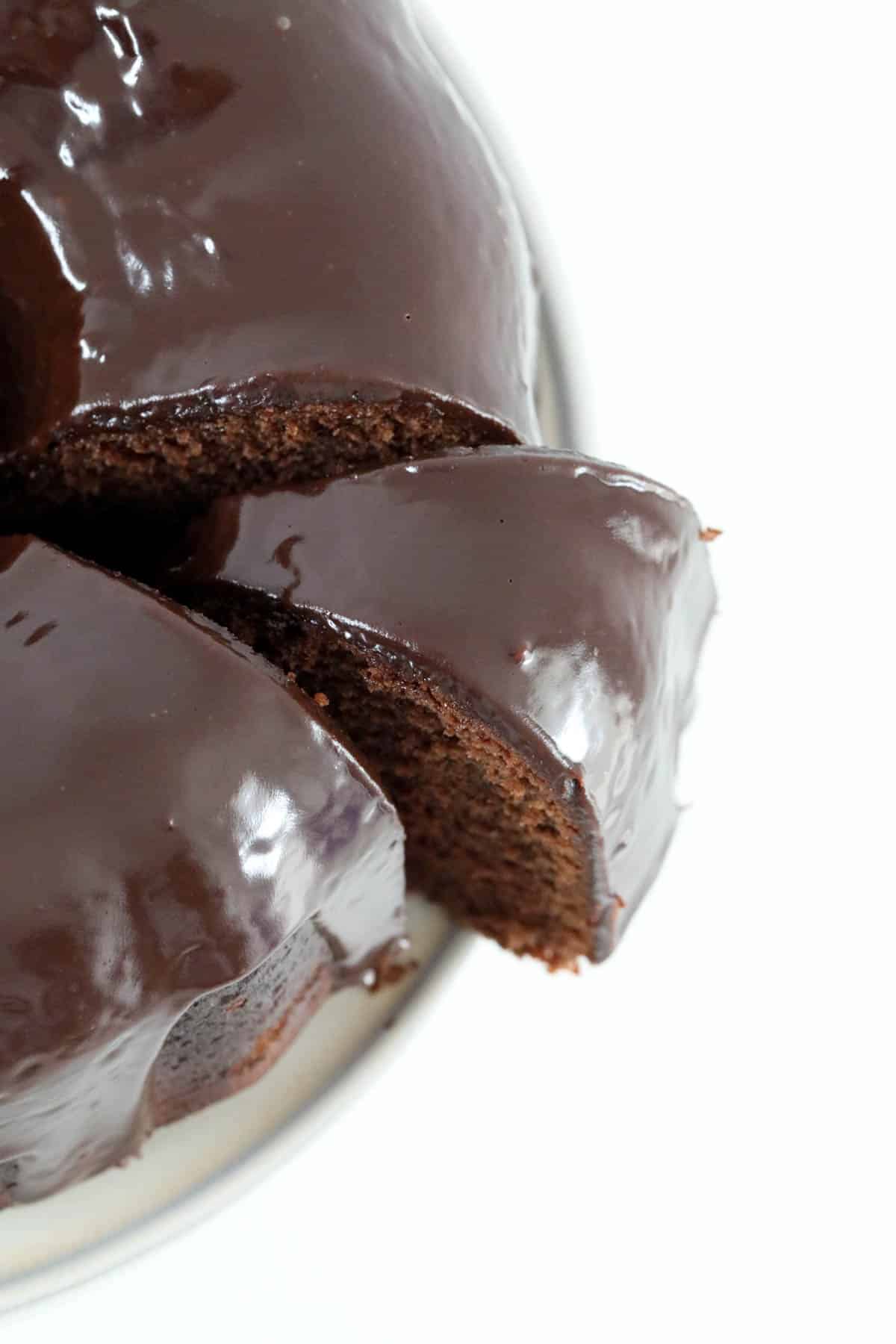 Close up of chocolate sour cream cake with the chocolate ganache poured over it.