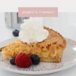 A slice of coconut pie served with cream on top and fresh berries.