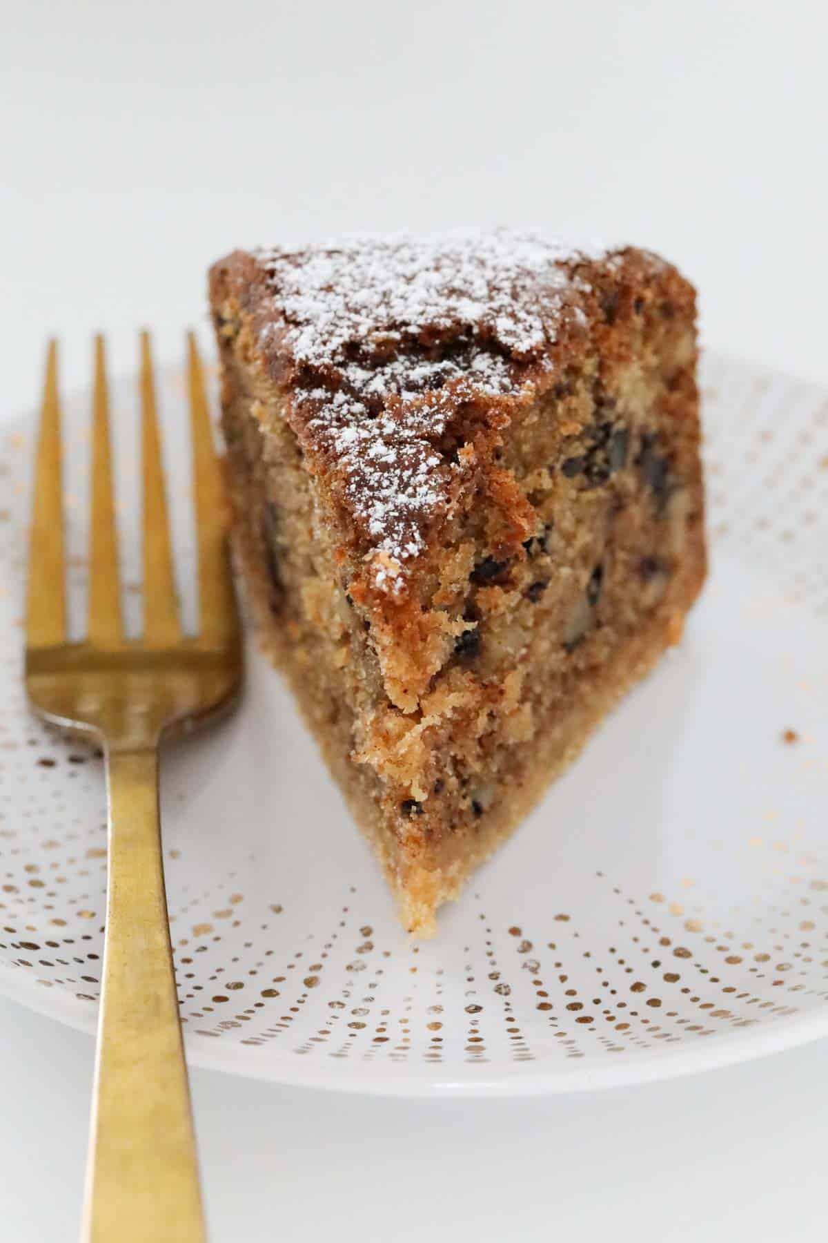 A serve of nutmeg cake showing the chopped walnuts throughout.