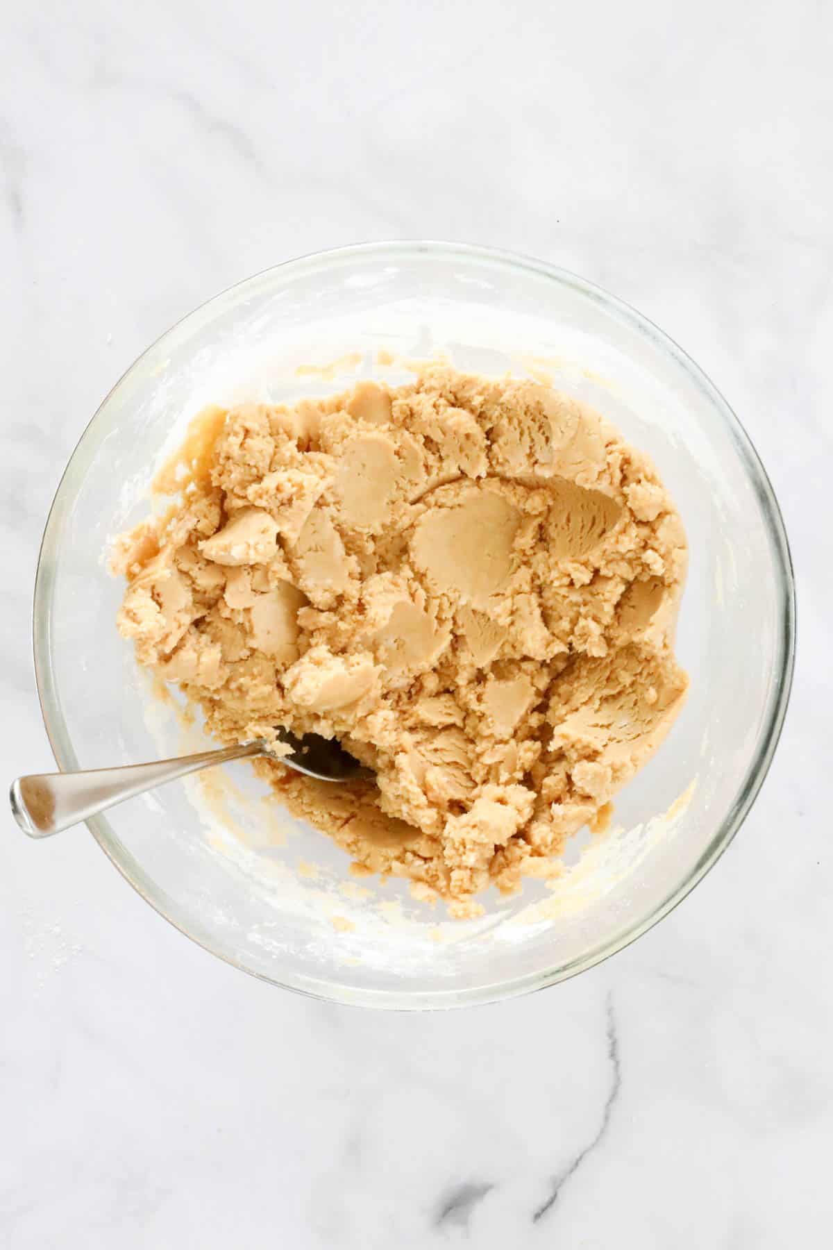 Thick fudge mixture in a bowl with a spoon.