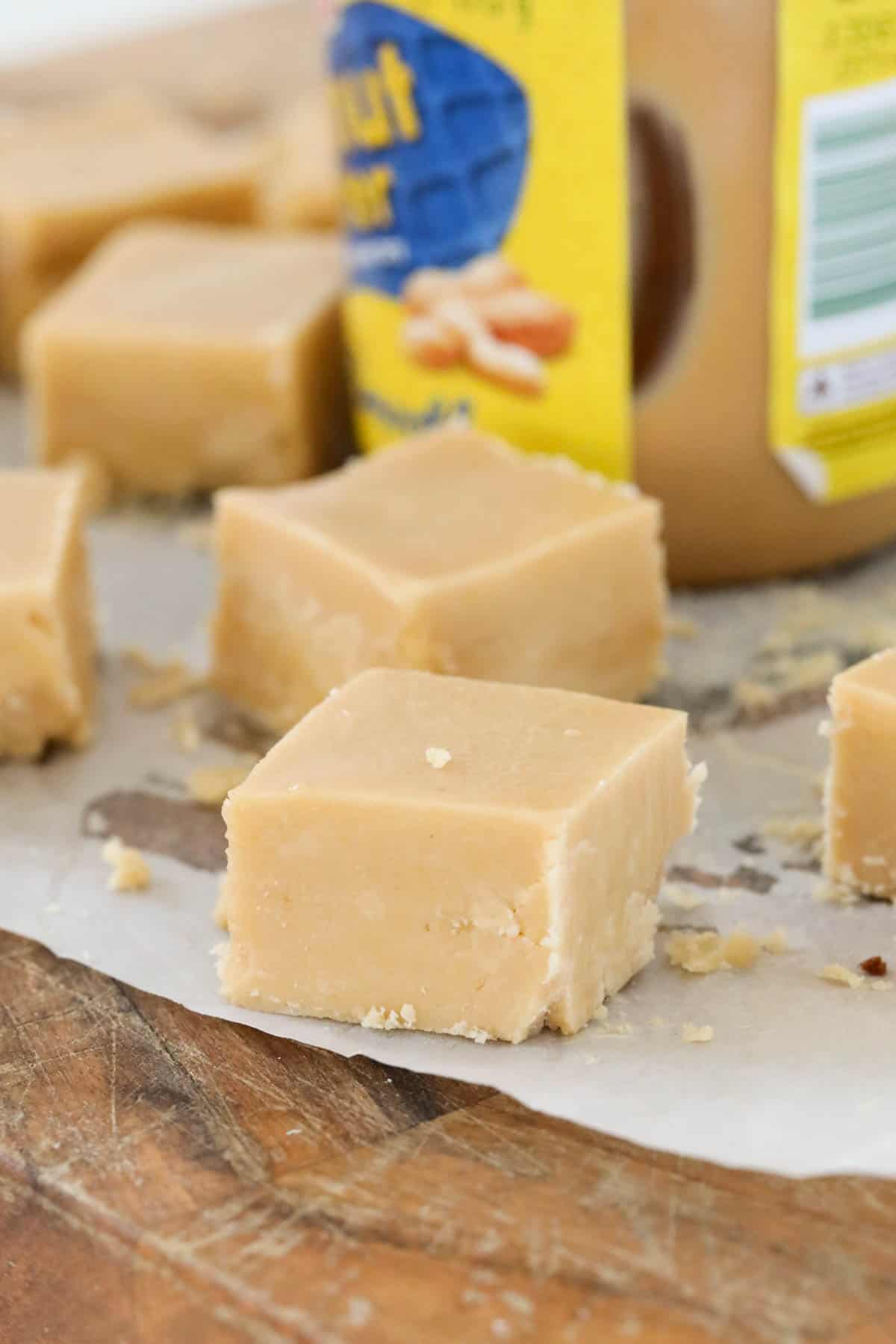 A close up of squares of golden fudge.