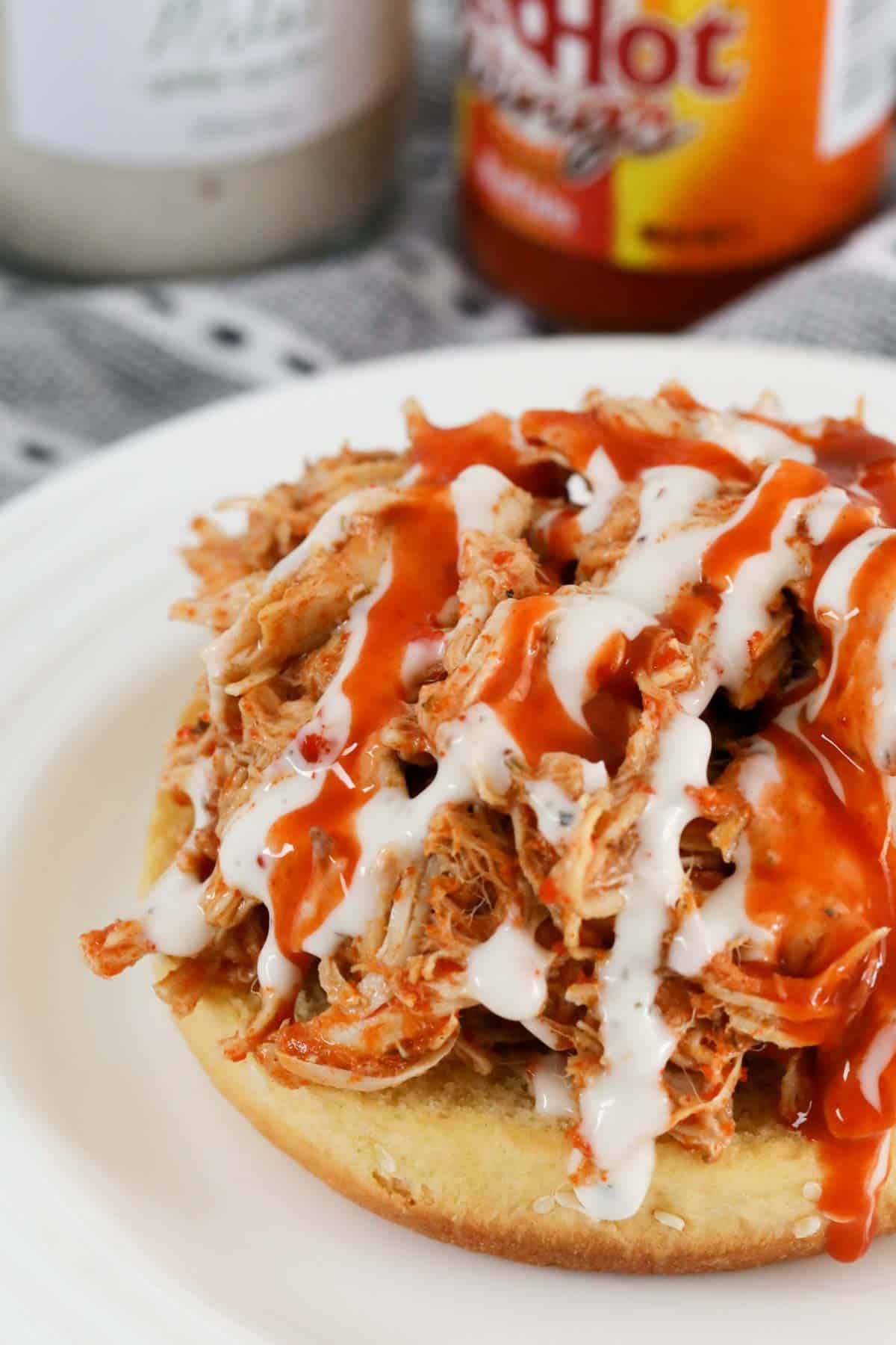 Hot and spicy sauce and creamy dressing drizzled on shredded chicken.