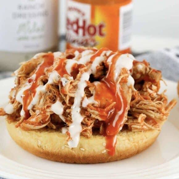 A buffalo shredded chicken sandwich with ranch sauce.