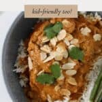 A grey bowl filled with a chicken korma curry, topped with flaked almonds and coriander.