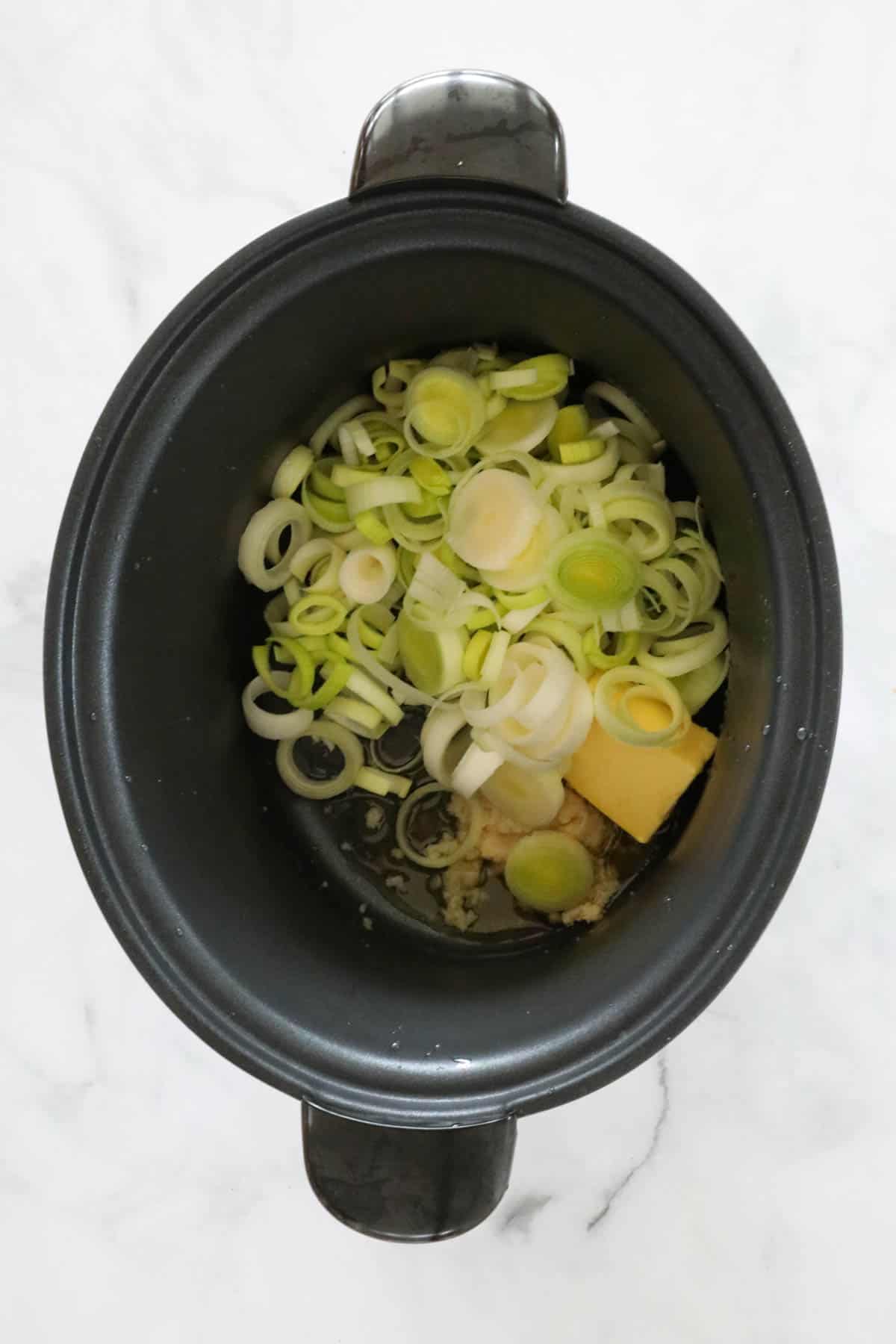 Leeks, garlic, butter and oil in a slow cooker.