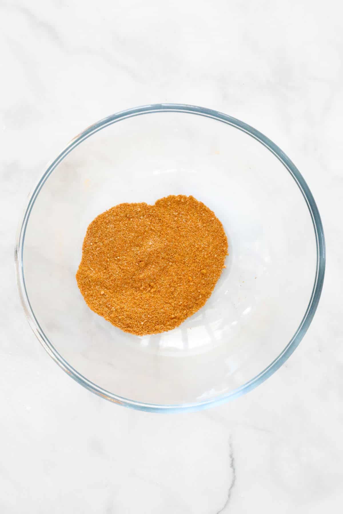 The satay spices mixed together in a mixing bowl.