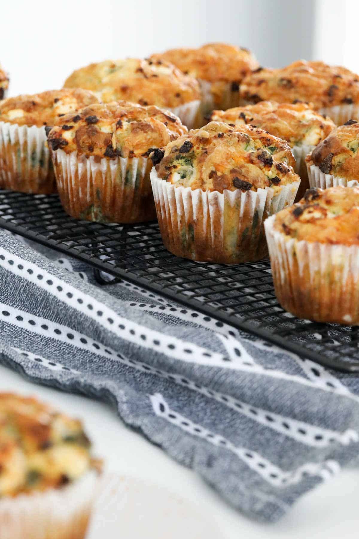 Baked feta and spinach muffins on a cooling rack.