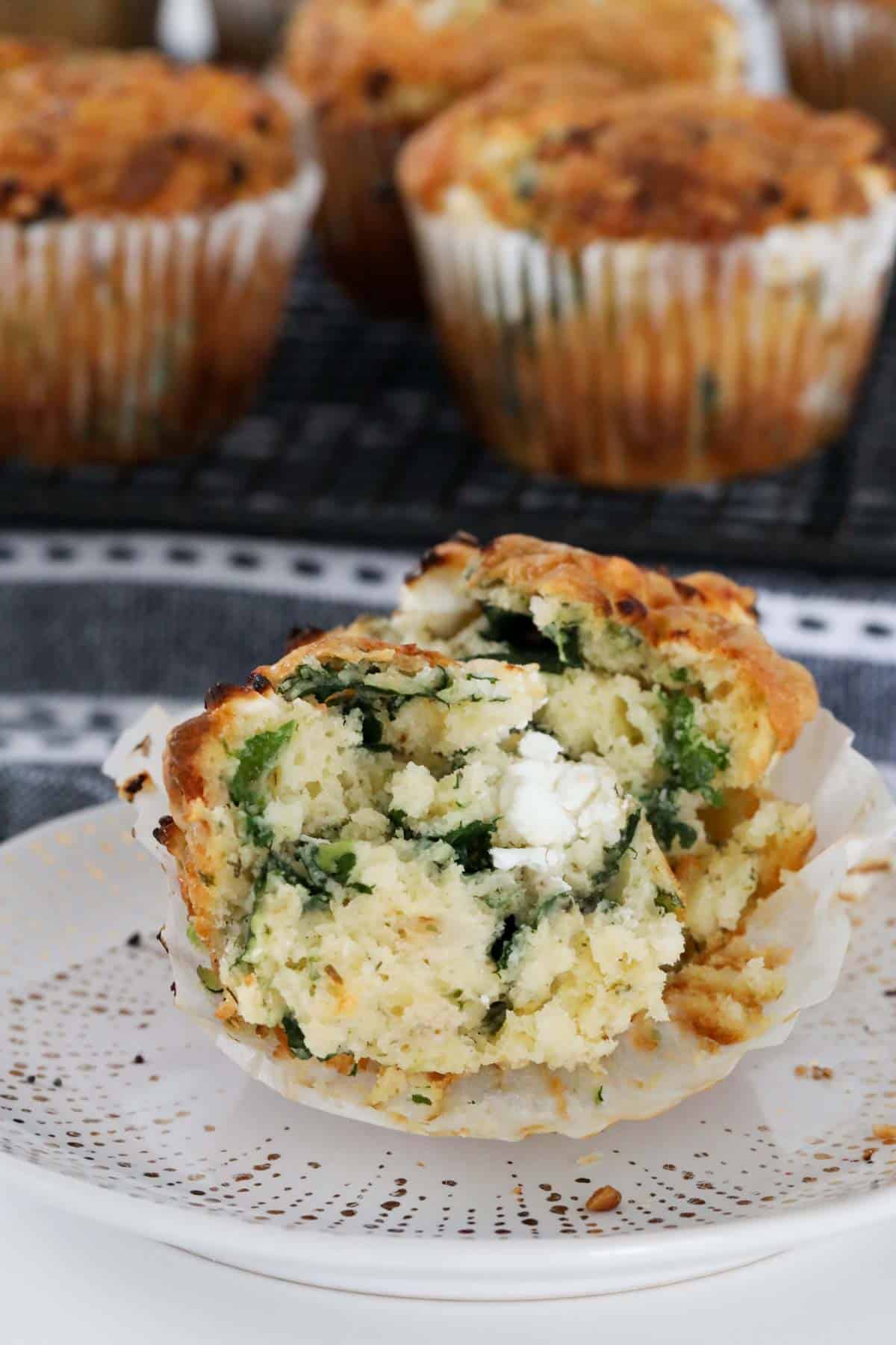 Spinach feta muffin on plate split in two to show the texture.