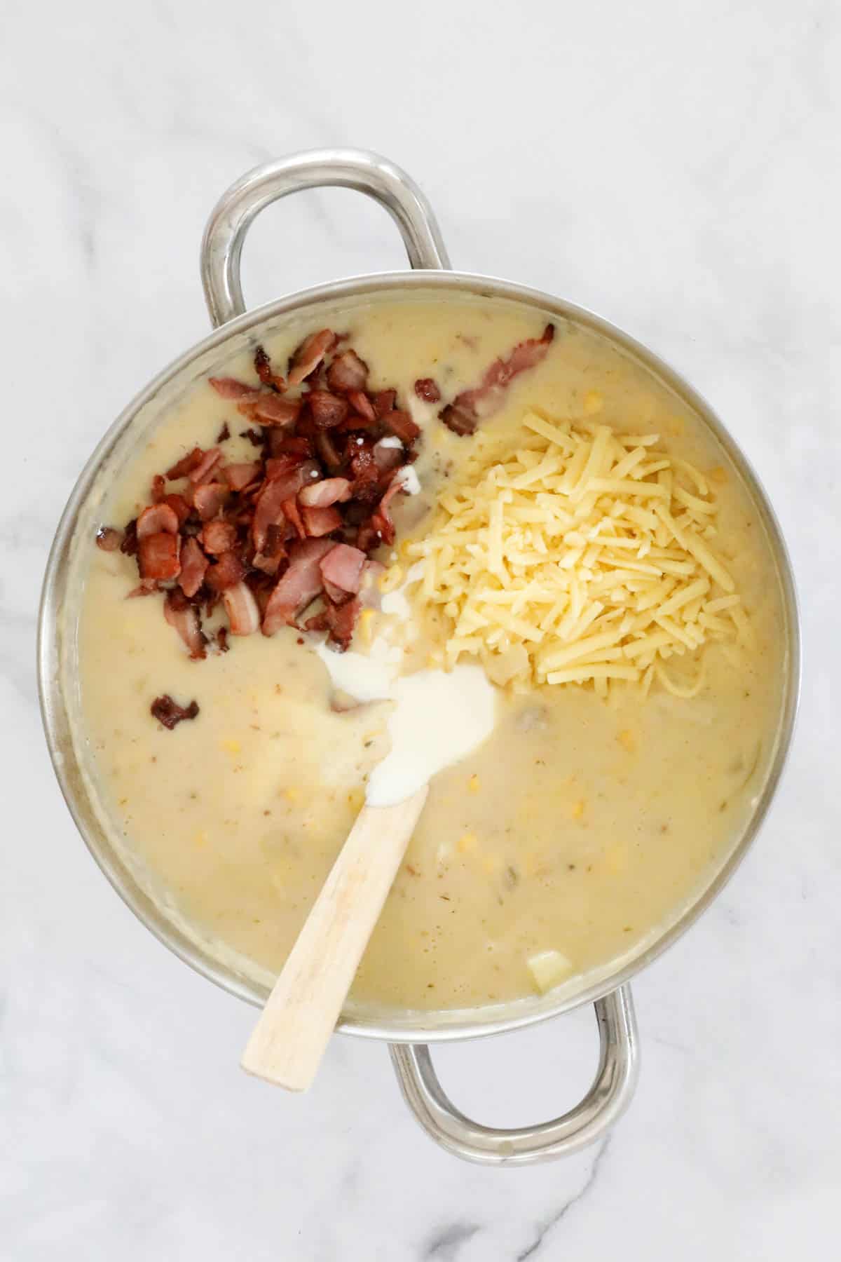 Grated cheese, crispy bacon and cream added to the soup.