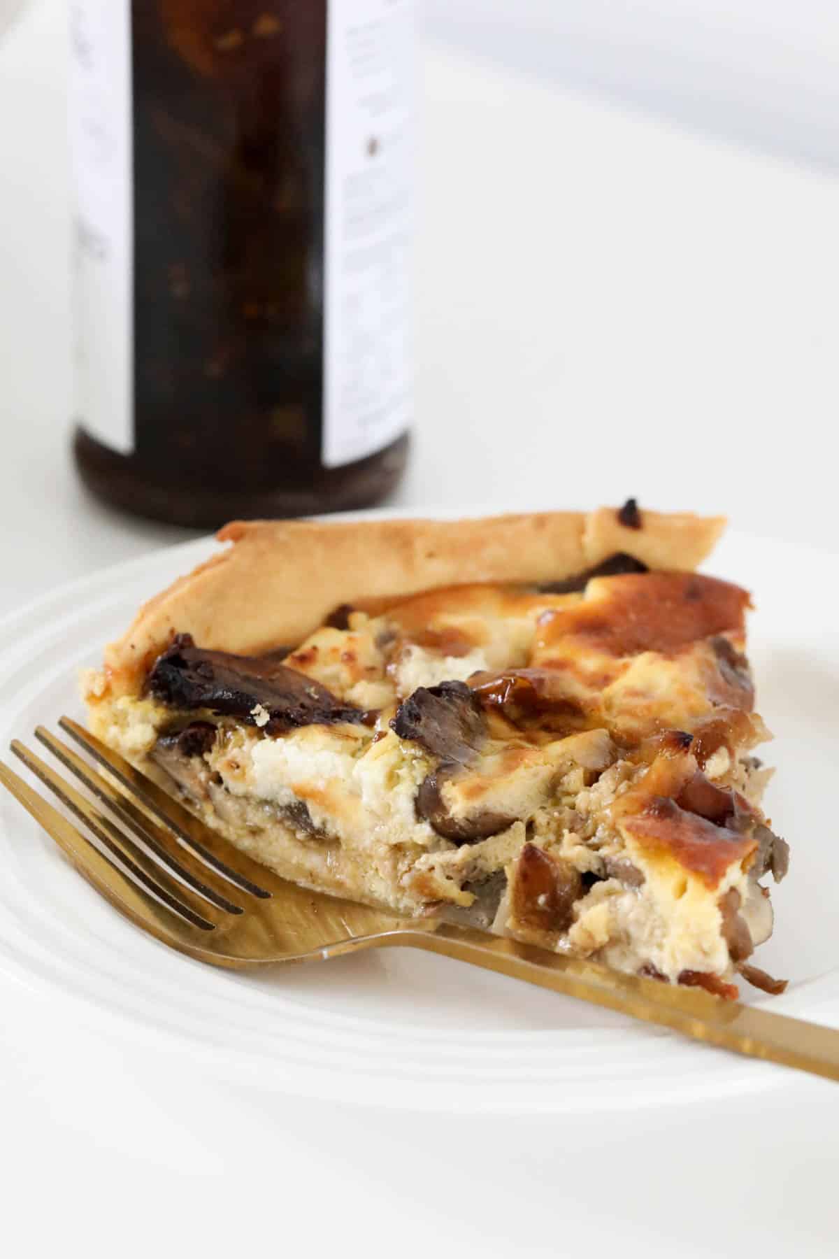 Mushroom tart served in front of a jar of caramelised onion relish.