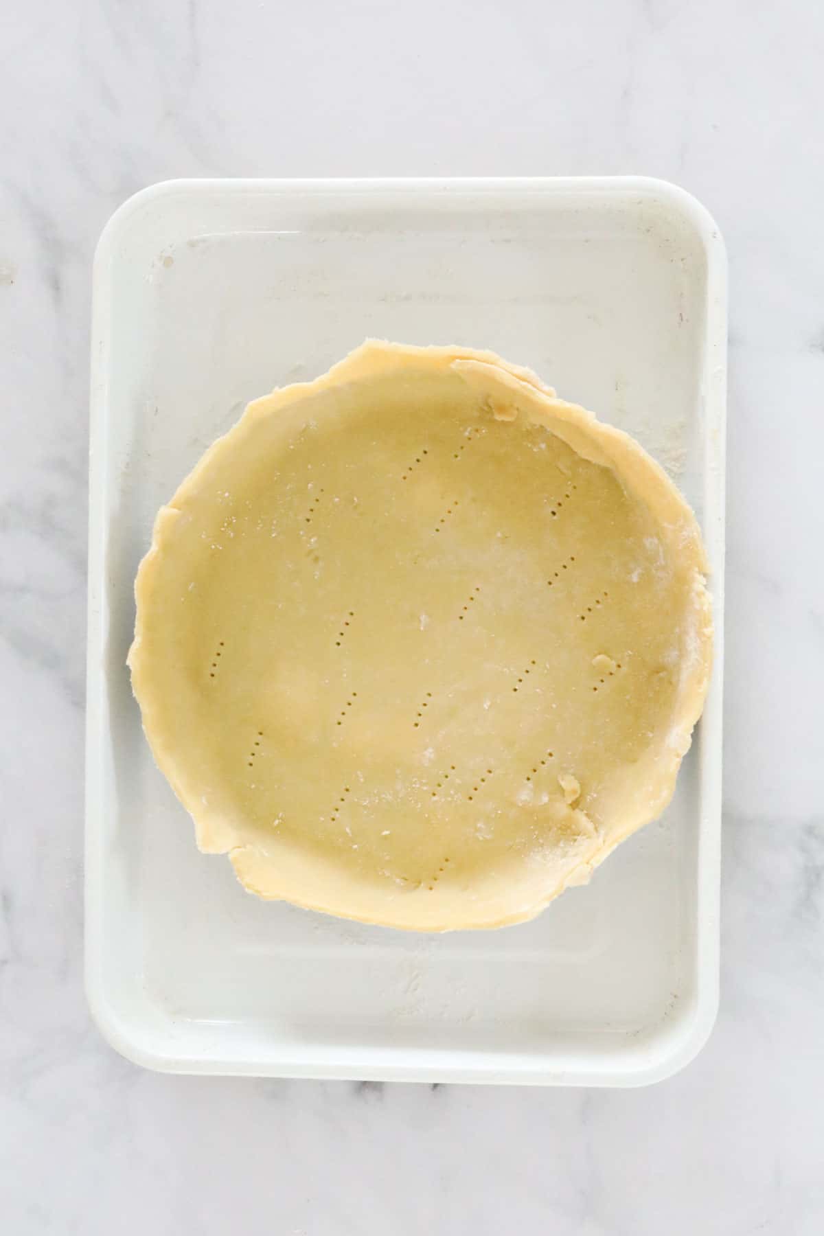 Uncooked pastry in a round pie dish