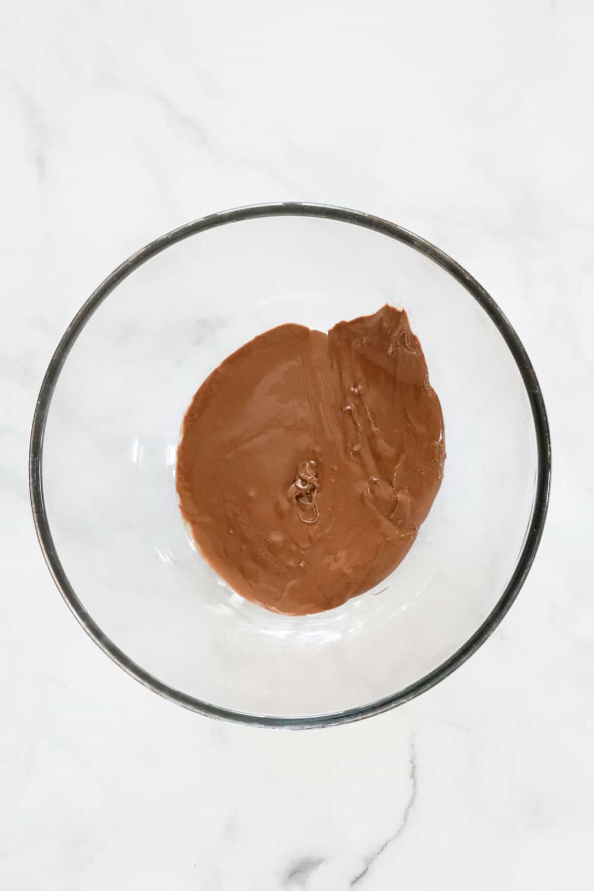 Hazelnut spread in a heatproof bowl after being in the microwave.