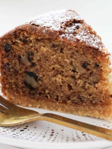 A piece of nutmeg cake with icing sugar on top.