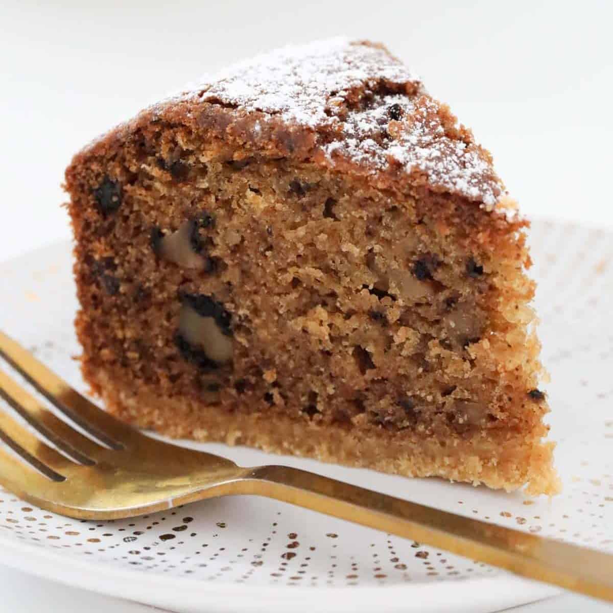 A piece of nutmeg cake with icing sugar on top.
