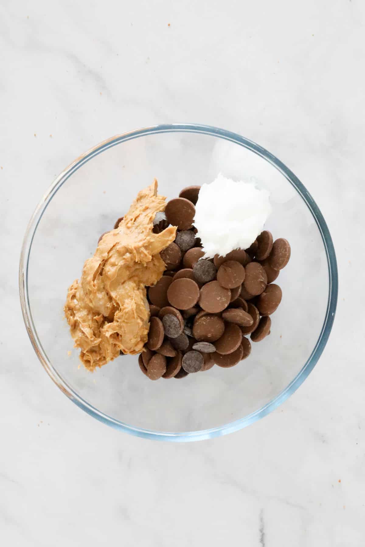 Chocolate, peanut butter and coconut oil in a glass bowl.