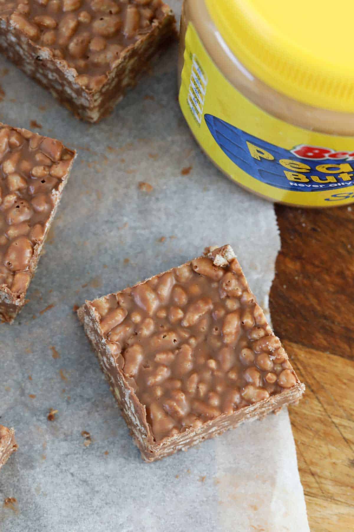 An overhead shot of a chocolate rice bubble slice with peanut butter.