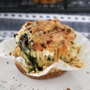 A golden baked muffin with baby spinach and feta.