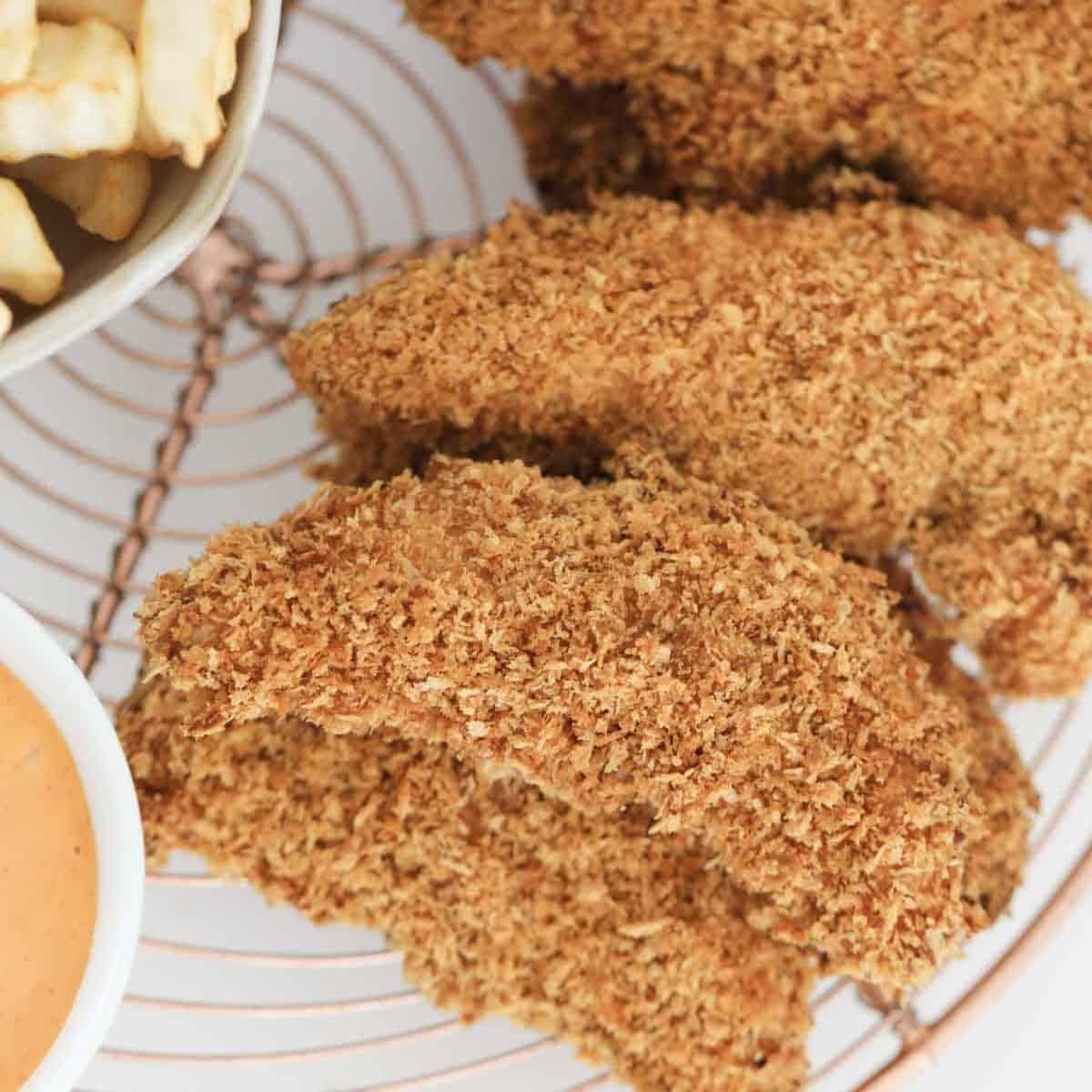 A plate of crispy oven baked Chicken Tenderloins.