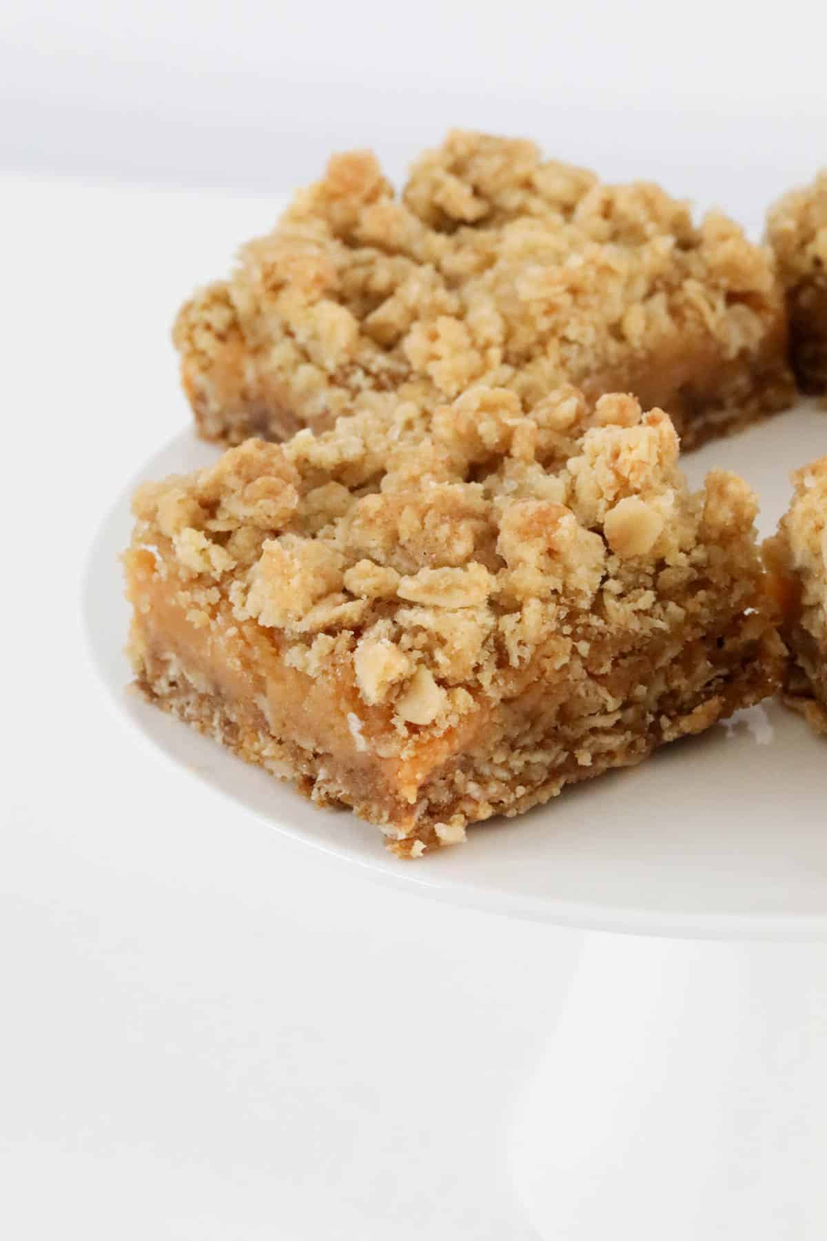 Squares of an oat crumble with caramel filling.