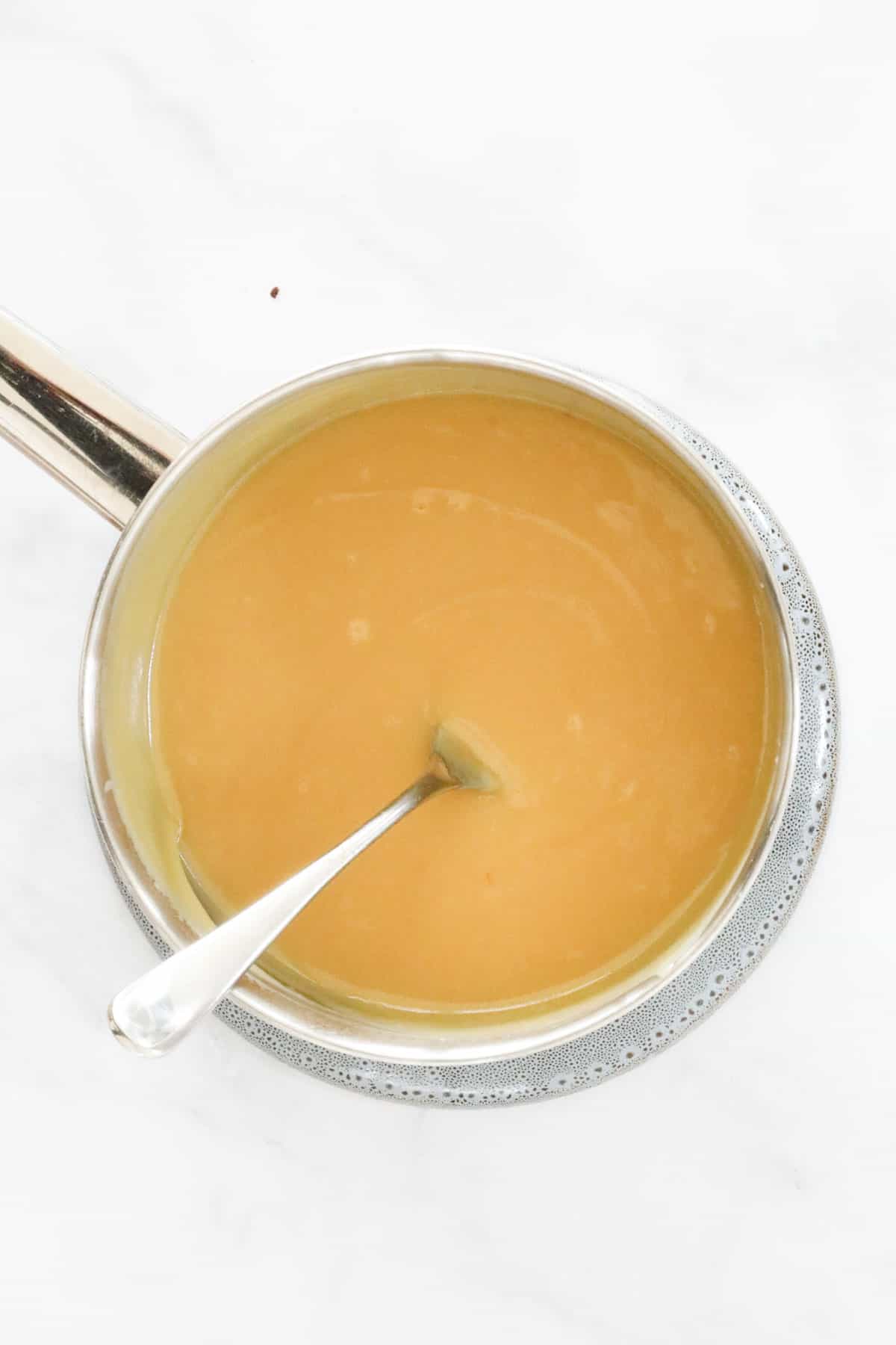 Melted butter mixed with condensed milk and golden syrup in a saucepan.
