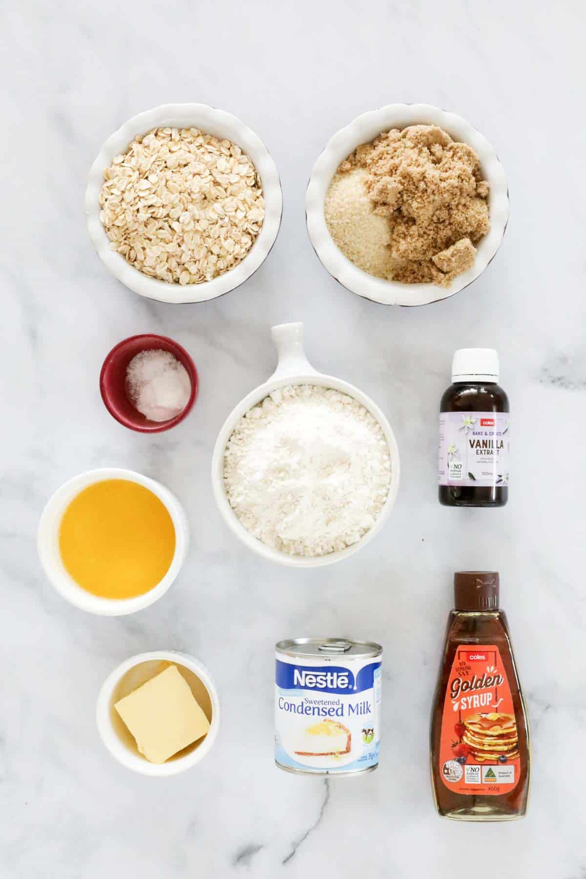 Ingredients for caramel oat slice set out on a bench top.