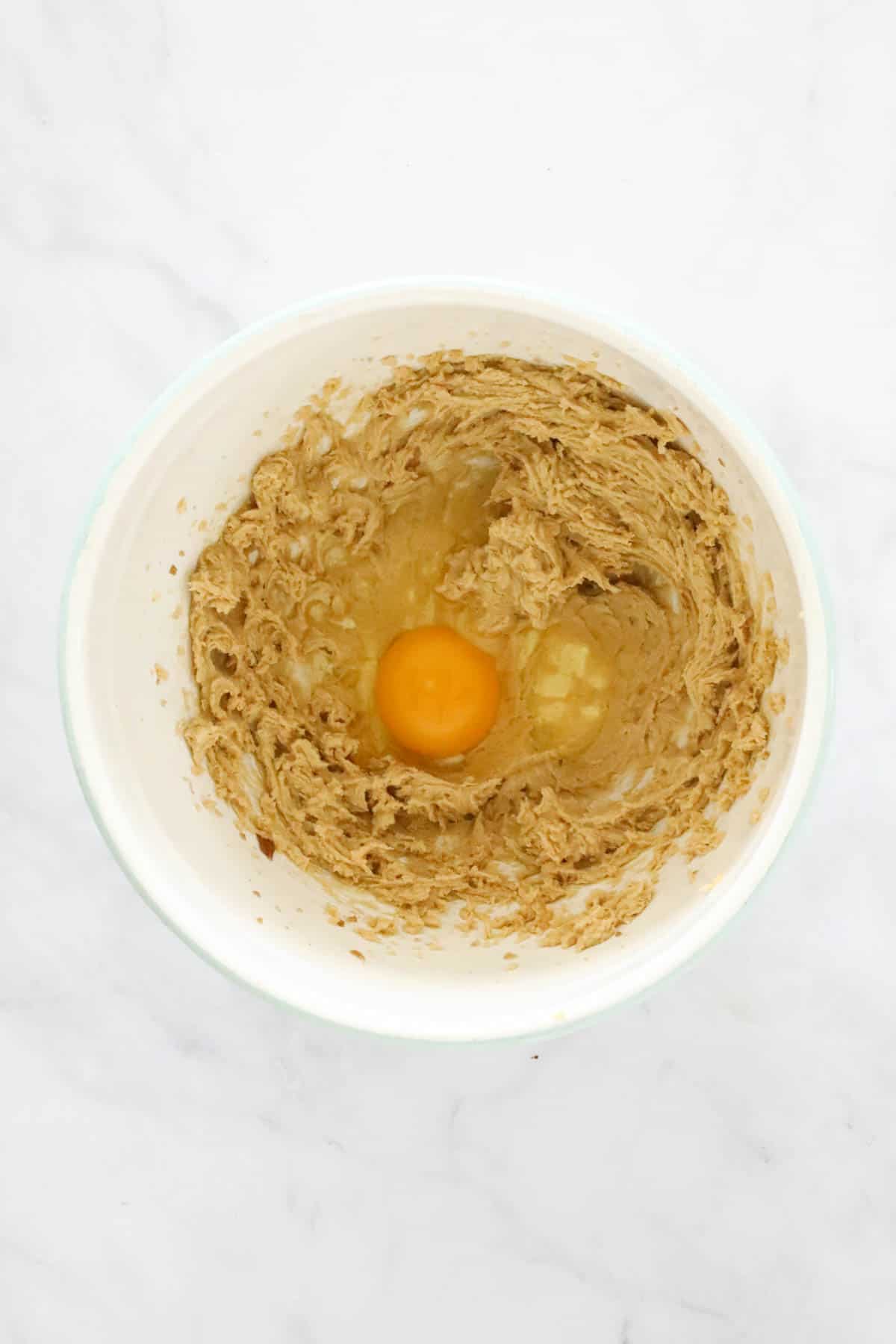 An egg added to creamed butter and sugar mixture.