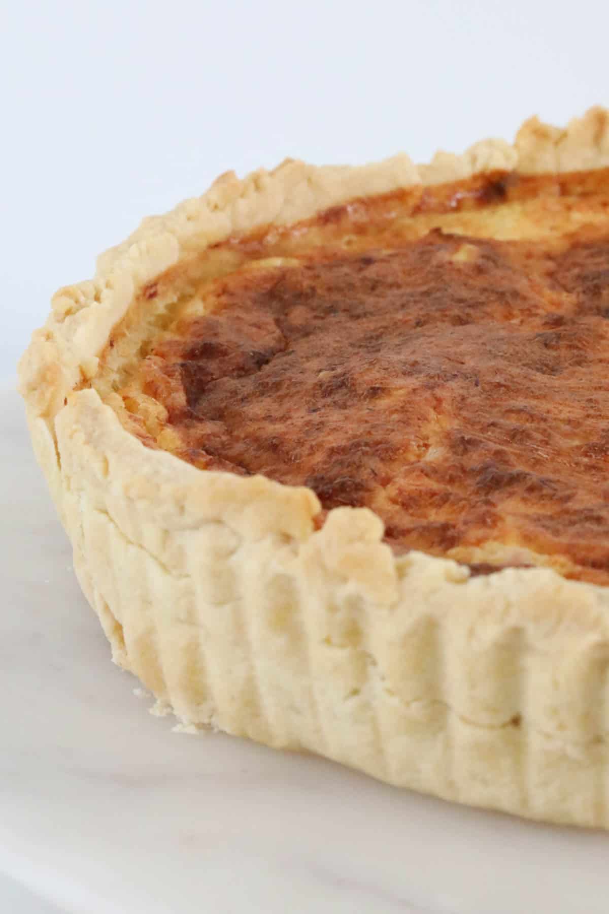 A close up of a Thermomix Quiche Lorraine made with homemade pastry.