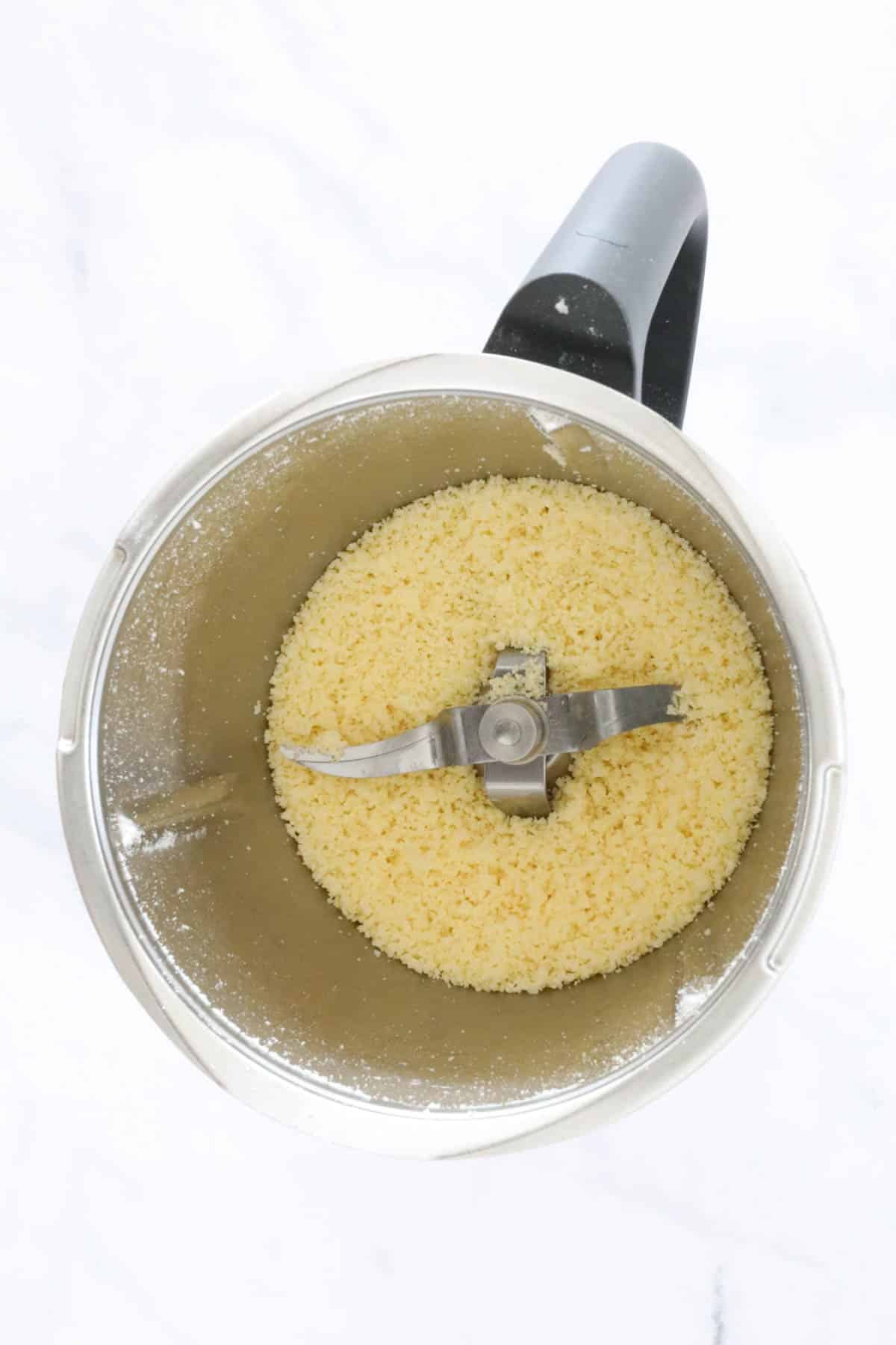 Grated cheese in a stainless bowl.