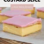 Squares of vanilla custard slice with pink glaze placed on baking paper.