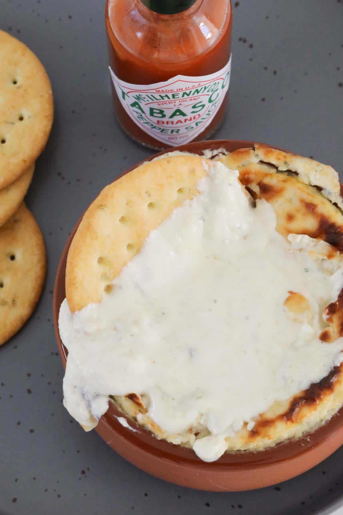 Blue cheese dip slathered over a cracker.
