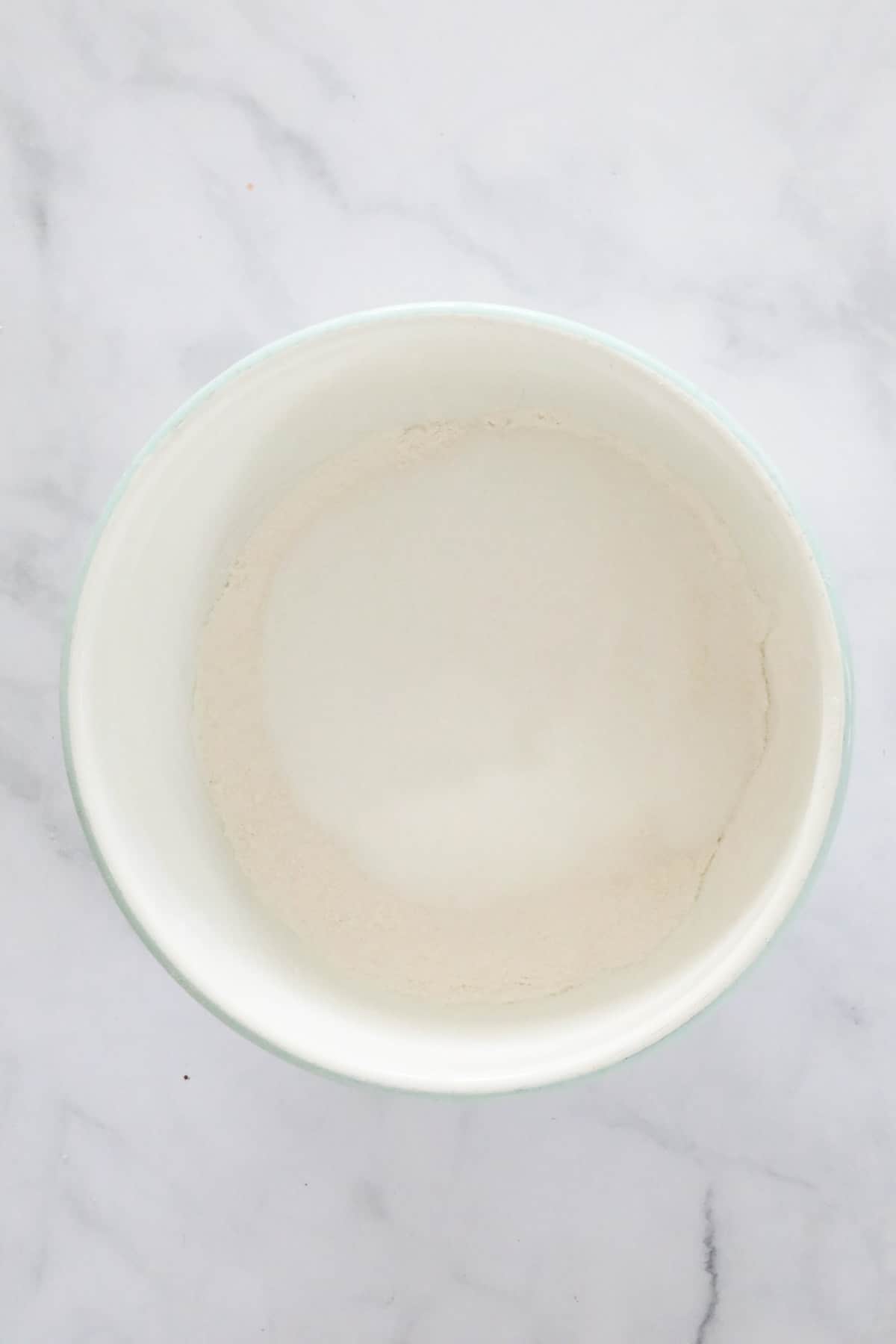 Flour in a white mixing bowl