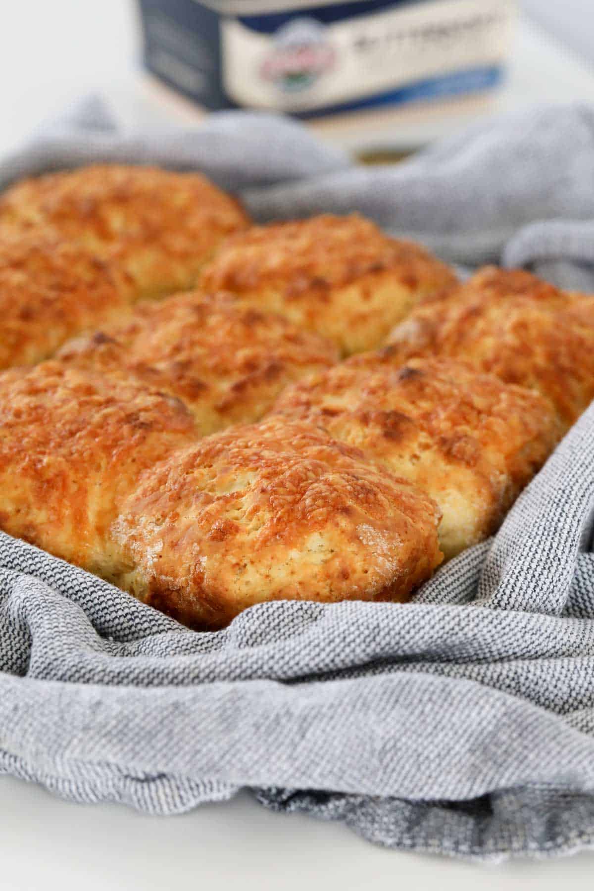 A batch of freshly baked cheese scones in a baking dish.