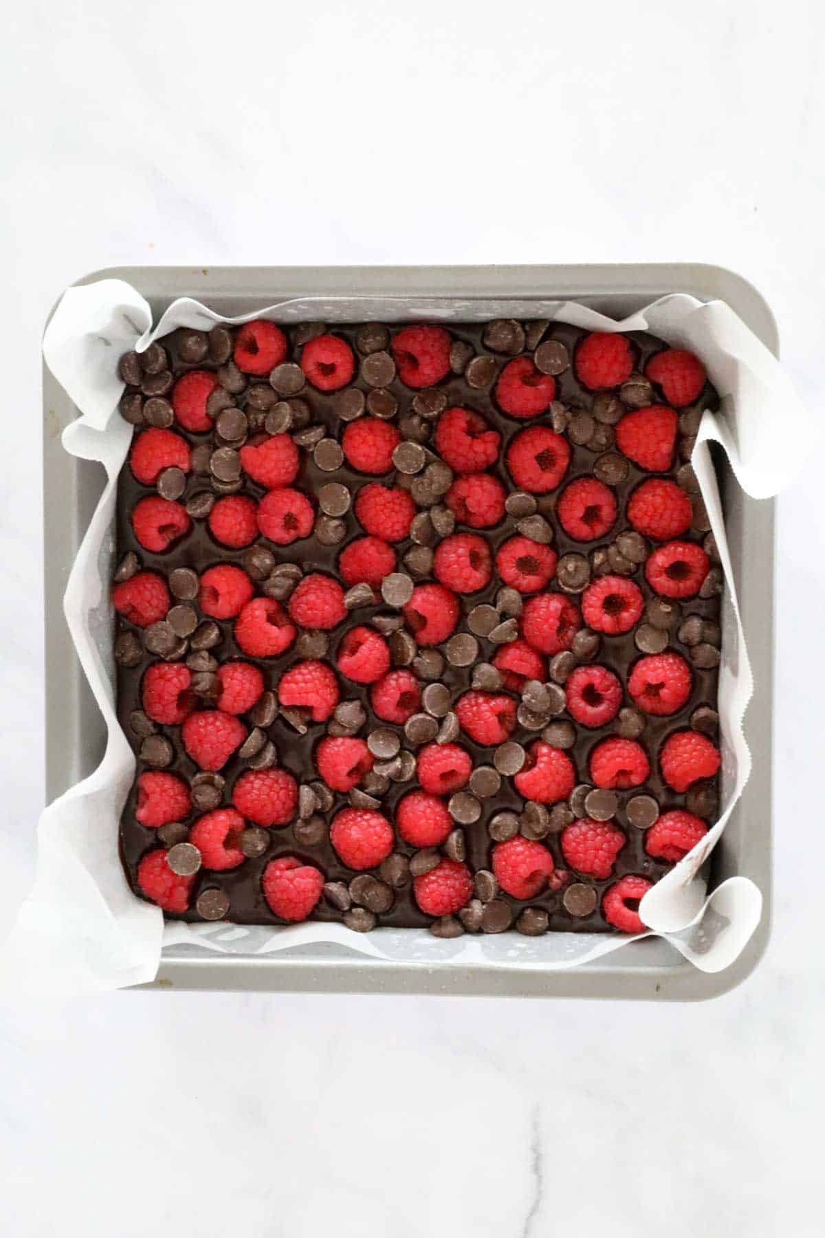 Fresh raspberries sprinkled over the top of the chocolate brownie.