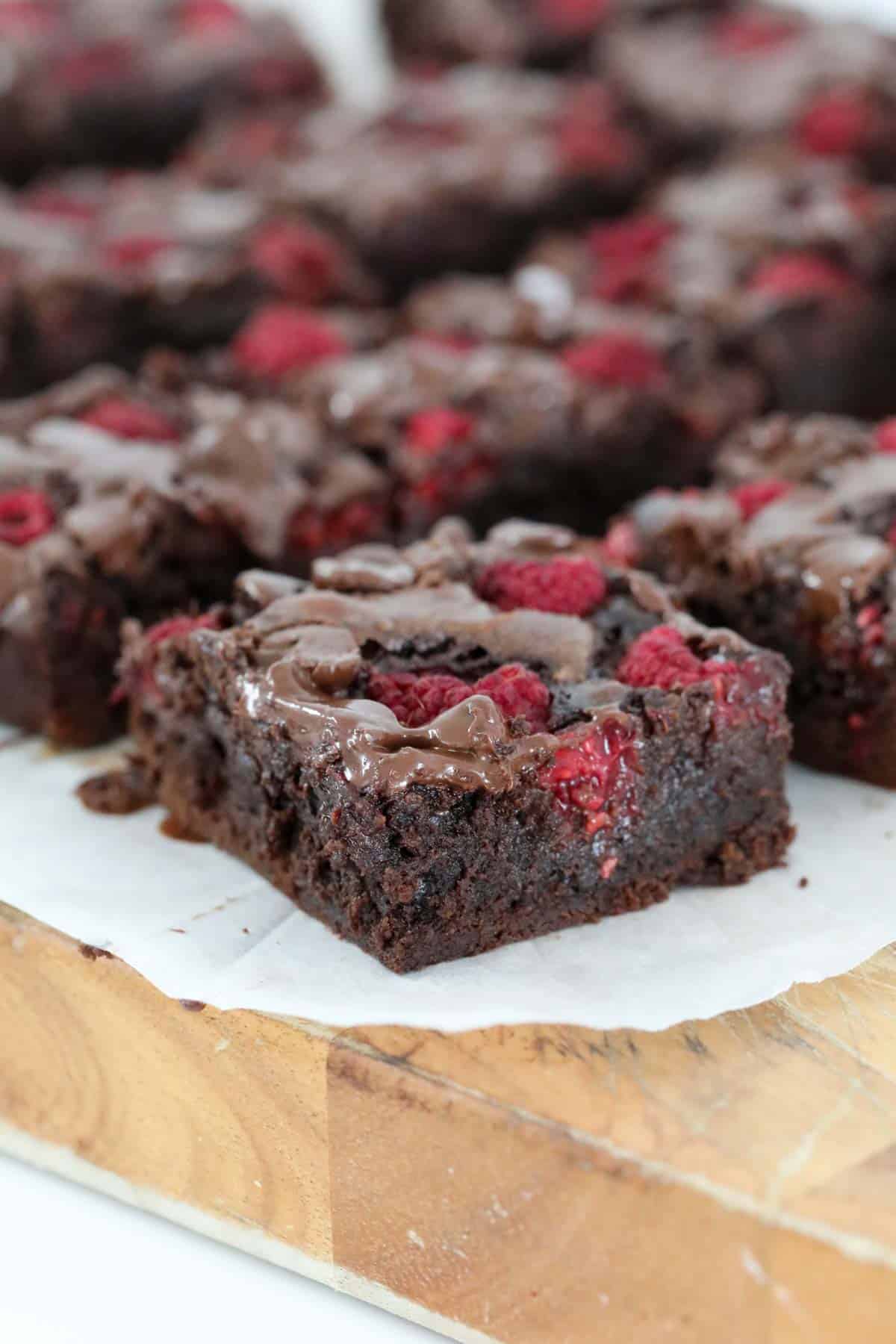 Fresh raspberries and chocolate chips on top of brownie squares.