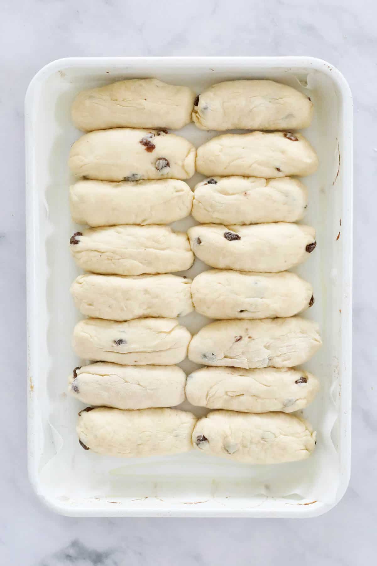 The dough shaped into finger bun shapes and placed on a baking tray.