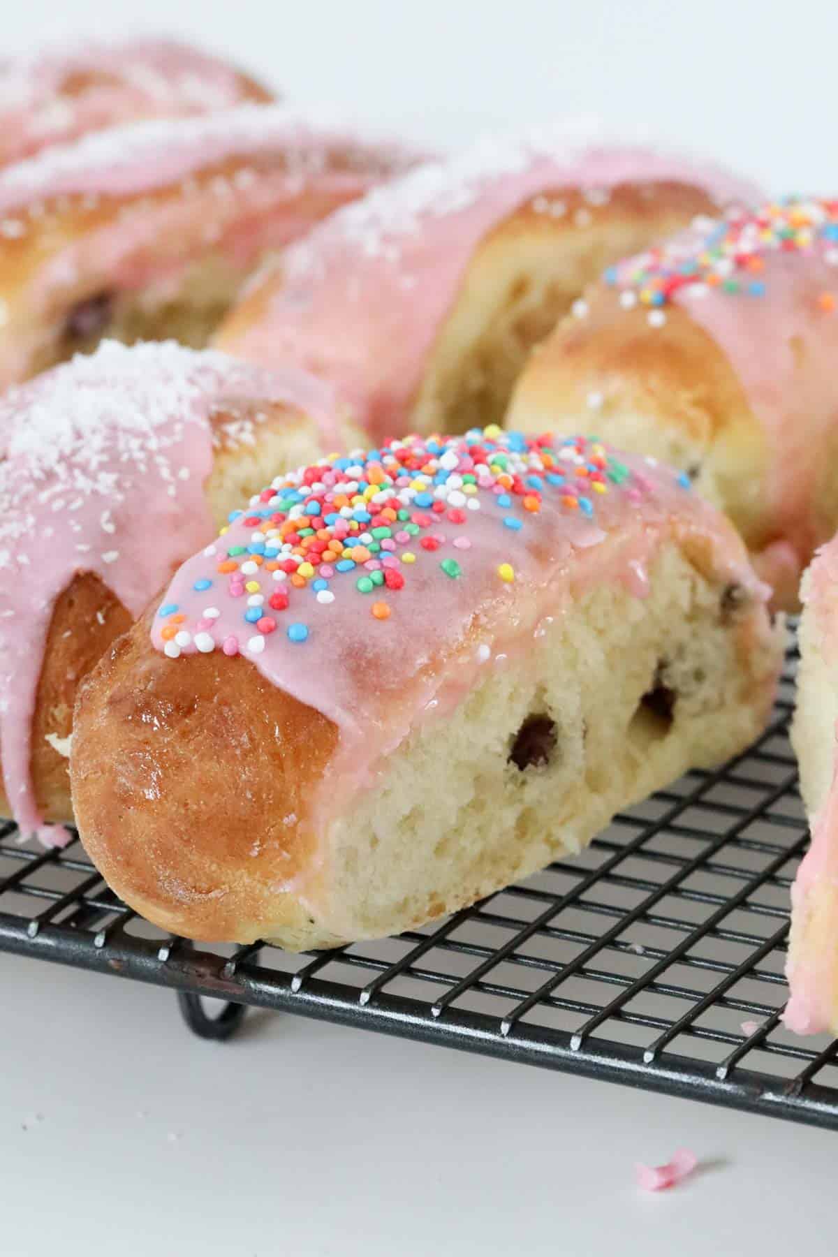 A close up of pink iced finger buns.