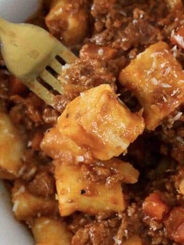A bowl of homemade ricotta gnocchi with bolognese sauce.