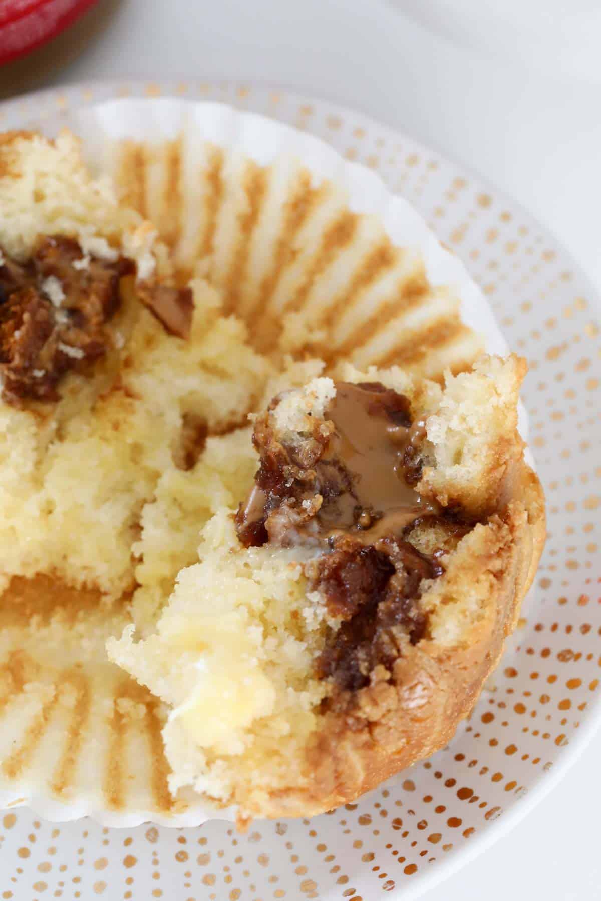 A muffin split open to show filling of soft Biscoff spread.
